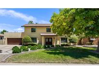 Inviting two-story home featuring a lush green lawn and mature trees at 538 W Las Palmaritas Dr, Phoenix, AZ 85021