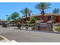 Savona community entrance featuring a stone sign, mature palm trees and well maintained landscaping at 955 E Knox Rd # 126, Chandler, AZ 85225