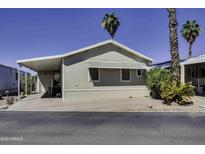 Charming home exterior with covered parking, trimmed green shrubs, and desert landscaping under a clear blue sky at 17200 W Bell Rd # 1602, Surprise, AZ 85374