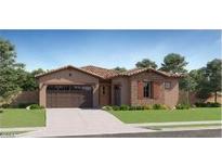Charming single-story home with a tile roof, desert landscaping, and an attached two-car garage at 17473 W Victory St, Goodyear, AZ 85338