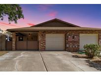 Charming brick home with a two-car garage and cozy covered patio, perfect for outdoor relaxation and curb appeal at 1807 E Jamaica Ave, Mesa, AZ 85204