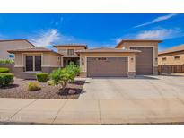 Charming single-Gathering home featuring a three-car garage, desert landscaping, and a neutral color palette at 18334 W Marshall Ln, Surprise, AZ 85388