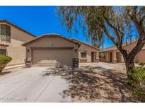 Charming single-story home with a well-maintained lawn, two-car garage, and desert landscaping at 2516 E San Manuel Rd, San Tan Valley, AZ 85143