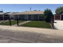 Charming home featuring a low fence with artificial turf and a lovely walkway at 2831 W Montecito Ave, Phoenix, AZ 85017