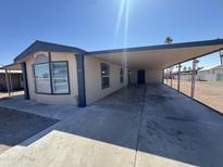 Home exterior featuring a long carport offering shade and protection for multiple vehicles at 318 N Pinal Dr, Apache Junction, AZ 85120