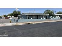 Charming single story home with a painted gray exterior and a block wall at 4502 N 50Th Ave, Phoenix, AZ 85031