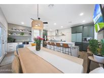 Open-concept kitchen features a large island with bar seating and modern, updated cabinetry at 5439 W Odeum Ln, Phoenix, AZ 85043
