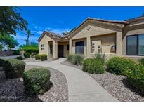 Inviting single-story home with desert landscaping, a tiled roof, and a walkway leading to the front door at 7575 E Indian Bend Rd # 1005, Scottsdale, AZ 85250