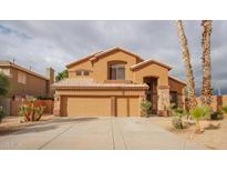 Inviting home with a three-car garage, neutral stucco and stacked stone accents at 760 N Swallow Ln, Gilbert, AZ 85234