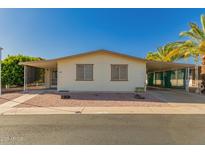 Charming single-story home with low-maintenance landscaping, carport, and mature palm trees at 8103 E Southern Ave # 69, Mesa, AZ 85209