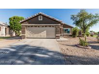 Charming single-story home featuring a neutral color, desert landscaping, and a two-car garage in a residential neighborhood at 8415 W Coolidge St, Phoenix, AZ 85037