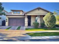 Charming single-story home featuring a stone-accented entrance, low-maintenance landscaping, and a two-car garage at 10538 E Naranja Ave, Mesa, AZ 85209