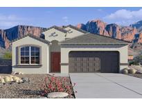 Charming single-story home with desert landscaping and a two-car garage, nestled against a backdrop of majestic mountains at 10556 W Bloch Rd, Tolleson, AZ 85353