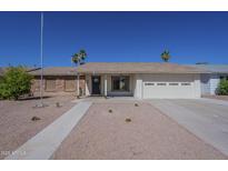 Charming single-story home with a well-maintained front yard, desert landscaping, and an attached two-car garage at 12234 S Pewaukee St, Phoenix, AZ 85044