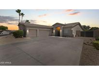 Charming home featuring a desert landscape, a wide driveway and a three car garage at 14621 W Catalina Dr, Goodyear, AZ 85395