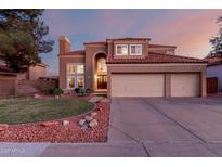 Stunning two-story home featuring a three-car garage and a well-manicured front yard at 1521 W Kent Dr, Chandler, AZ 85224