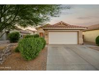 Charming single-story home with a two-car garage, desert landscaping, and a warm, inviting curb appeal at 2006 W Gold Dust Ave, Queen Creek, AZ 85144