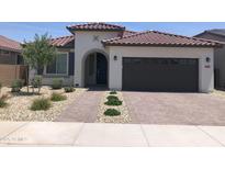 Charming single-story home with desert landscaping, paver driveway and dark garage door at 25109 N 173Rd Dr, Surprise, AZ 85387