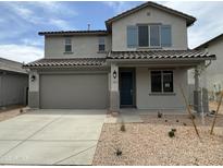 Charming two-story home features a two car garage, blue door, and low maintenance desert landscaping at 31822 N Bandit Rd, San Tan Valley, AZ 85143