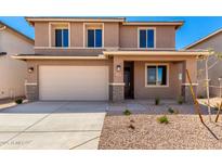 Two-story home with a front yard featuring desert landscaping, attached garage, and neutral color palette at 31850 N Bandit Rd, San Tan Valley, AZ 85143