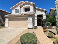 Charming two-story home with desert landscaping, brick walkway, and attached two-car garage at 4034 E Anderson Dr, Phoenix, AZ 85032