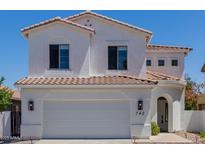 Inviting two-story home featuring a neutral-colored exterior, arched entryway, and a spacious two-car garage at 742 W Vineyard Plains Dr, San Tan Valley, AZ 85143