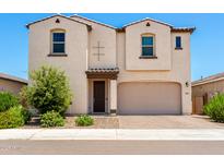 Charming two-story home with stucco siding, landscaped front yard, and a covered entryway at 10625 S 55Th Dr, Laveen, AZ 85339