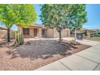 Charming single-Gathering home with desert landscaping, mature trees, and a two-car garage at 11318 W Monte Vista Rd, Avondale, AZ 85392