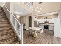 Spacious living room featuring staircase, chandelier, dining area and kitchen at 1367 S Country Club Dr # 1331, Mesa, AZ 85210
