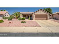 Charming single-story home featuring desert landscaping and a two-car garage at 15314 W Pantano Dr, Surprise, AZ 85374