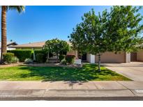 Charming single story home showcasing a well-manicured lawn, mature trees, and inviting curb appeal at 1862 E Tulane Dr, Tempe, AZ 85283
