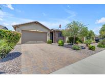 Charming single-story home with a paver driveway, low maintenance landscaping, and a two car garage at 19606 W Grant St, Buckeye, AZ 85326
