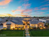 Stunning twilight shot of the home's exterior showing manicured lawn, walkway, and inviting facade at 2652 E Pelican Ct, Gilbert, AZ 85297