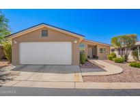 Charming single-story home features a two-car garage and low maintenance desert landscaping at 3301 S Goldfield Rd # 1048, Apache Junction, AZ 85119