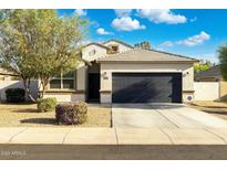 Charming single-story home with a well-maintained lawn, desert landscaping, and a two-car garage at 36033 W Catalonia Dr, Maricopa, AZ 85138