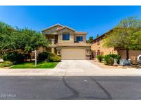 Charming two-story home featuring desert landscaping, tile roof, and an attached two-car garage at 5234 E Carol Ave, Mesa, AZ 85206