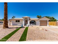 Charming single-story home featuring desert landscaping and a welcoming brick pathway to the front door at 715 S Saranac Ave, Mesa, AZ 85208