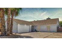 Charming single-story home with a well-maintained lawn and a two car garage at 7431 W Mclellan Rd, Glendale, AZ 85303