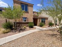 Charming two-story home with desert landscaping, walkway, and inviting front entrance at 8218 W Illini St, Phoenix, AZ 85043