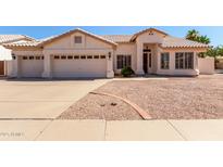 Charming single-story home featuring a well-maintained front yard, a two-car garage, and a welcoming entrance at 871 W Mesquite St, Gilbert, AZ 85233