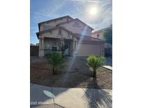 Charming two-story home with a well-manicured front yard and attached two-car garage at 9205 W Williams St, Tolleson, AZ 85353