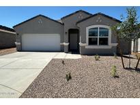 Charming single-story home with a well-maintained front yard and a two-car garage at 18331 W Hackamore Dr, Wittmann, AZ 85361