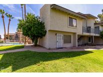 Charming condo featuring a secure entrance, green grass, and refreshing pool access for a comfortable lifestyle at 19601 N 7Th St # 1022, Phoenix, AZ 85024