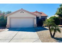 Charming single-story home with a well-maintained front yard and two car garage, perfect for suburban living at 244 N Rock St, Gilbert, AZ 85234