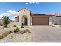 Inviting single-Gathering home featuring a stucco facade, a tile roof, and a well-manicured desert landscape in front at 26824 W Ponderosa Ln, Buckeye, AZ 85396