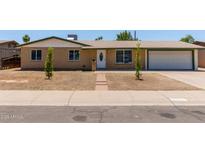 Charming single-story home featuring a well-maintained brick facade, attached garage, and minimal landscaping at 3539 W Davidson Ln, Phoenix, AZ 85051