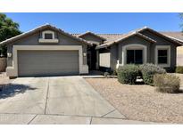 Charming single-story home featuring a two-car garage, desert landscaping, and a tile roof at 3844 E Bruce Ave, Gilbert, AZ 85234