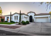 Beautiful single-story home with well-manicured landscaping, and a three-car garage at 4636 E Carriage Ct, Gilbert, AZ 85297