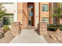 Inviting building entrance with stone pillars and landscaped surroundings at property address 4909 at 4909 N Woodmere Fairway -- # 1004, Scottsdale, AZ 85251