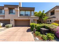 Charming townhome featuring a two-car garage and beautifully landscaped front yard at 7400 E Gainey Club Dr # 203, Scottsdale, AZ 85258